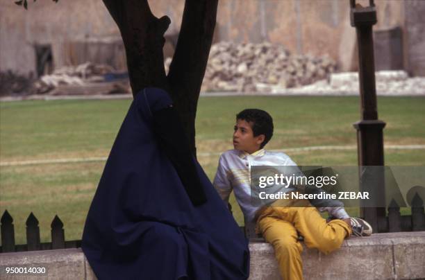 Femme voilée avec un enfant en mai 1993 dans un jardin public au Caire en Egypte.