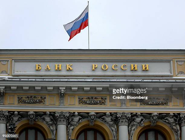 The Russian flag flies atop Russia's central bank in Moscow, Russia, on Tuesday, Dec. 22, 2009. Russia's borrowing costs in international markets...