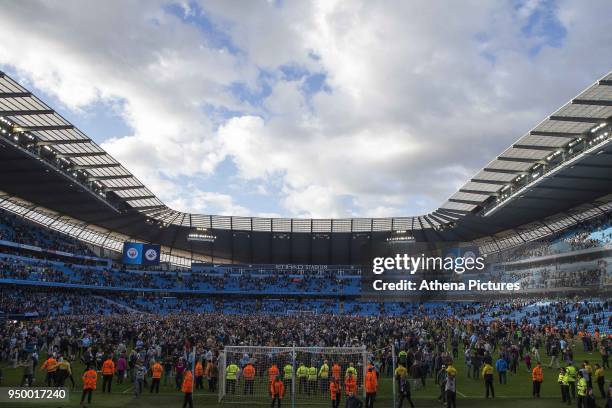 Manchester City fans invade the pitch after the Premier League match between Manchester City and Swansea City at the Etihad Stadium on April 22, 2018...