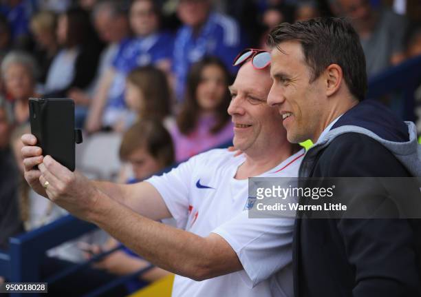 Phil Neville, England women's head coach is pictured with a fan ahead of during the UEFA Womens Champions League semi-final first leg match between...