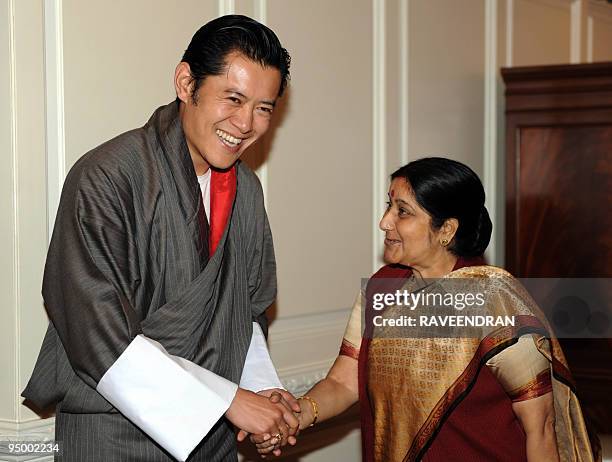 King of Bhutan, Jigme Khesar Namgyel Wangchuck shakes hands with India's new opposition leader Sushma Swaraj during a meeting in New Delhi on...