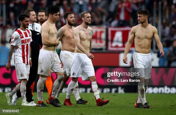 Leonardo Bittencourt of Koeln and his team mates walks off dejected after the Bundesliga match between 1. FC Koeln and FC Schalke 04 at...