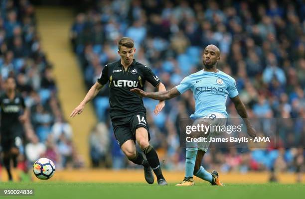 Tom Carroll of Swansea City and Fabian Delph of Manchester City during the Premier League match between Manchester City and Swansea City at Etihad...