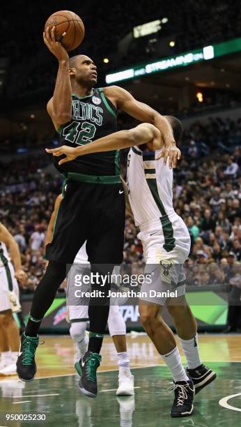 Al Horford of the Boston Celtics gets off a shot over Jabari Parker of the Milwaukee Bucks during Game Four of Round One of the 2018 NBA Playoffs at...