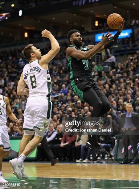 Jaylen Brown of the Boston Celtics drives past Matthew Dellavedova of the Milwaukee Bucks during Game Four of Round One of the 2018 NBA Playoffs at...