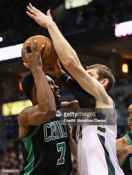 Jaylen Brown of the Boston Celtics tries to get off a shot against Tyler Zeller of the Milwaukee Bucks during Game Four of Round One of the 2018 NBA...