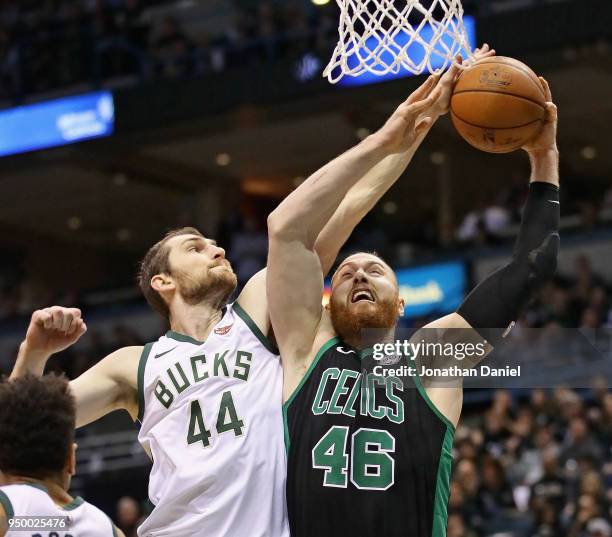 Tyler Zeller of the Milwaukee Bucks blocks a shot by Aron Baynes of the Boston Celtics but gets called for a foul during Game Four of Round One of...