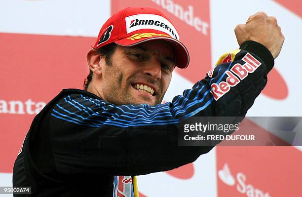 Red Bull's Australian driver Mark Webber celebrates on the podium of the Nurburgring racetrack on July 12, 2009 in Nurburg, after the German Formula...
