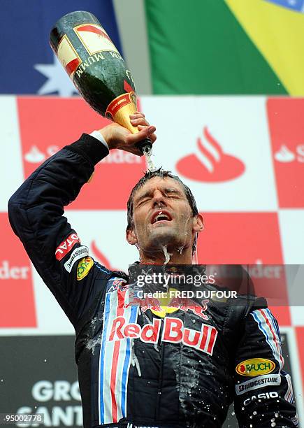 Red Bull's Australian driver Mark Webber celebrates on the podium of the Nurburgring racetrack on July 12, 2009 in Nurburg, after the German Formula...