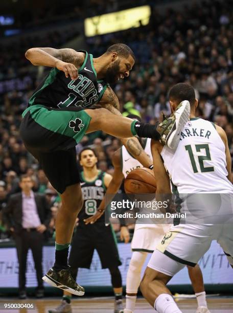 Marcus Morris of the Boston Celtics looses control of the ball under pressure from Jabari Parker of the Milwaukee Bucks during Game Four of Round One...