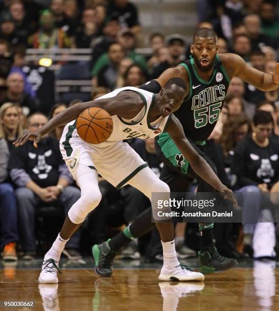 Thon Maker of the Milwaukee Bucks looses control of the ball under pressure from Greg Monroe of the Boston Celtics during Game Four of Round One of...