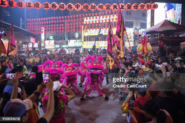 Lion dancers perform at Jenn Lann Temple during festivities marking the end of the nine day Mazu pilgrimage, on April 22, 2018 in Dajia near...