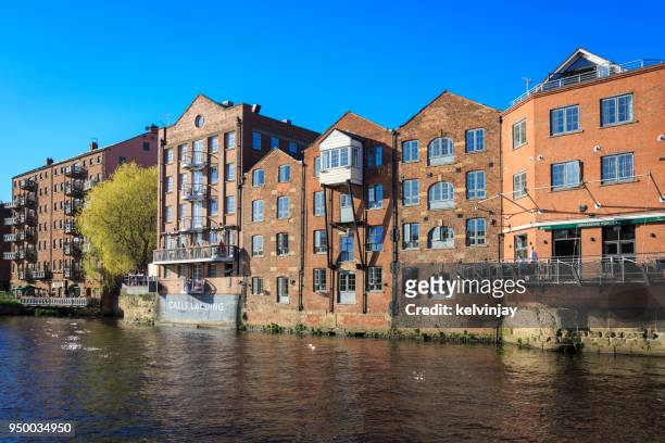 apartments, bars and restaurants on the river aire in leeds, yorkshire. - kelvinjay stock pictures, royalty-free photos & images