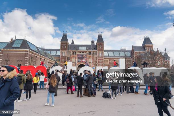 amsterdam outside rijksmuseum tourists walk on the street (ed) - basilica of st nicholas amsterdam stock pictures, royalty-free photos & images