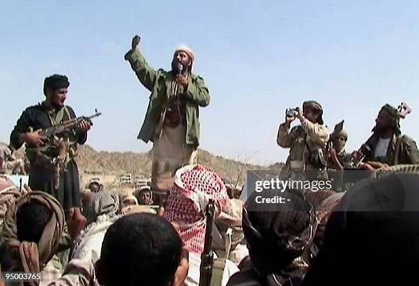 Man claiming to be an Al-Qaeda member addresses a crowd gathered in Yemen's southern province of Abyan on December 22, 2009. Men claiming to be...