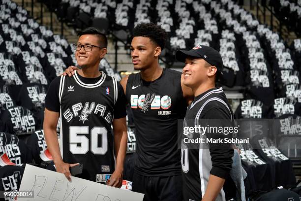 Dejounte Murray of the San Antonio Spurs poses for a photo with fans before Game Four of the Western Conference Quarterfinals against the Golden...