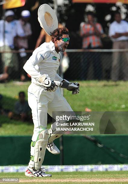 Sri Lankan wicketkeeper Tillakaratne Dilshan celebrates the dismissal of Pakistan cricketer Khurram Manzoor during the second day of the second Test...