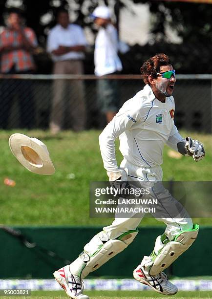 Sri Lankan wicketkeeper Tillakaratne Dilshan celebrates the dismissal of Pakistan cricketer Khurram Manzoor during the second day of the second Test...