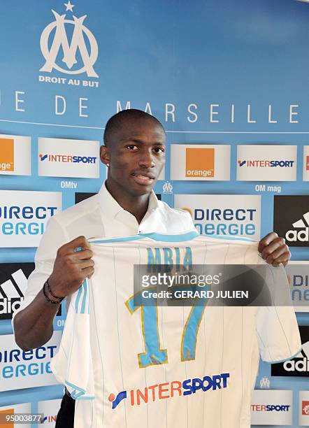 Cameroon international midfielder Stephane Mbia poses with his new jersey of the Olympic of Marseille football club, during his presentation at the...