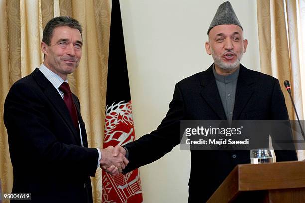 Secretary-General Anders Fogh Rasmussen and Afghanistan's President Hamid Karzai shake hands during a news conference at the Presidential palace on...