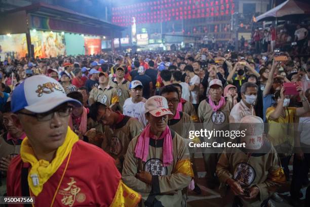 People wait in the temple grounds following the arrival of the goddess Mazu at Jenn Lann Temple on the final day of the nine day Mazu pilgrimage, on...