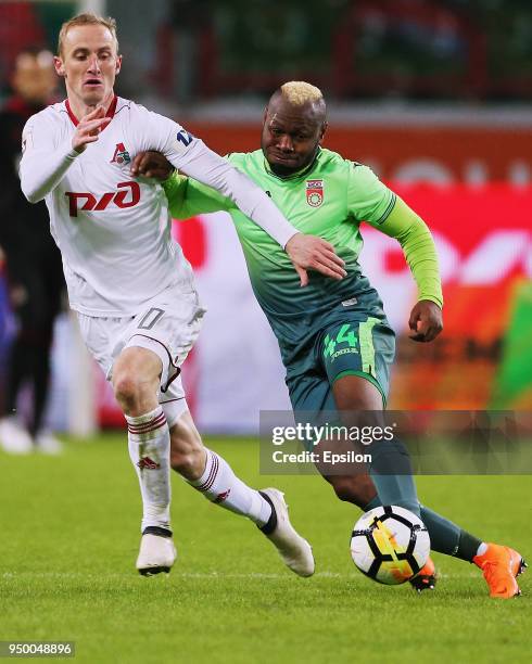 Vladislav Ignatyev of FC Lokomotiv Moscow vies for the ball with Sylvester Igboun of FC Ufa during Russian Premier League between FC Lokomotiv Moscow...