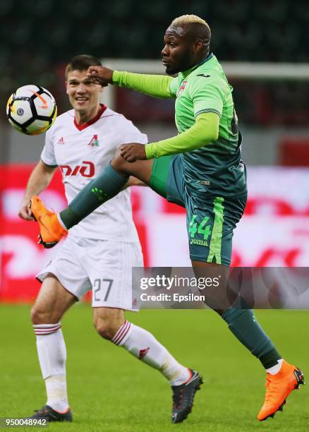 Igor Denisov of FC Lokomotiv Moscow vies for the ball with Sylvester Igboun of FC Ufa during Russian Premier League between FC Lokomotiv Moscow and...