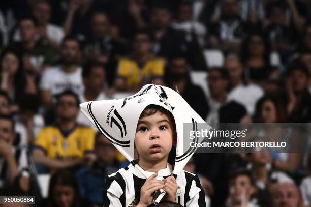 Young Juventus'supporter looks on during the Italian Serie A football match between Juventus and Napoli on April 22, 2018 at the Allianz Stadium in...