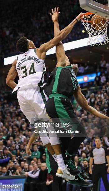 Giannis Antetokounmpo of the Milwaukee Bucks dunks over Al Horford of the Boston Celtics during Game Four of Round One of the 2018 NBA Playoffs at...