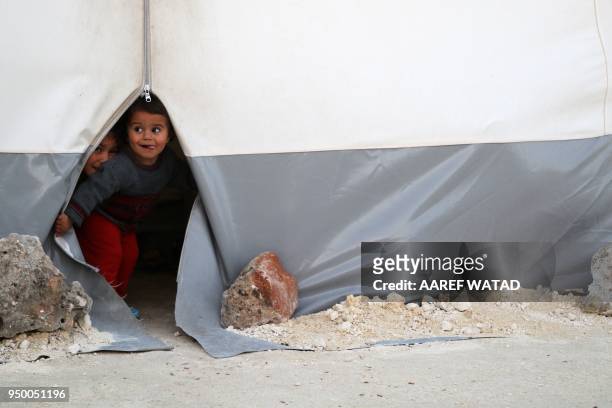 Syrian children evacuated from Eastern Ghouta play at a camp for displaced people in Bab al-Hawa, in Syria's northen province of Idlib, on April 22,...