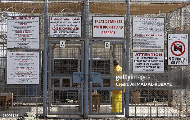 Warning signs are hung on a security fence in the Taji prison, north of Baghdad, on December 2, 2009. The command of the Taji prison will be...