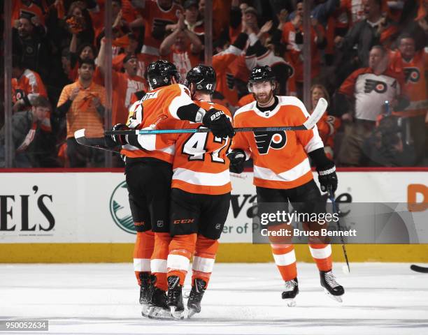 Ivan Provorov, Andrew MacDonald and Sean Couturier of the Philadelphia Flyers celebrate a goal by MacDonald at 15:48 of the first period against the...