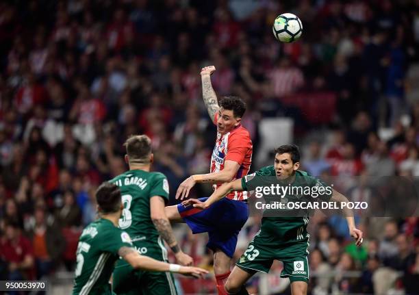 Atletico Madrid's Uruguyan defender Jose Gimenez vies with Real Betis' Algerian defender Aissa Mandi during the Spanish league football match between...