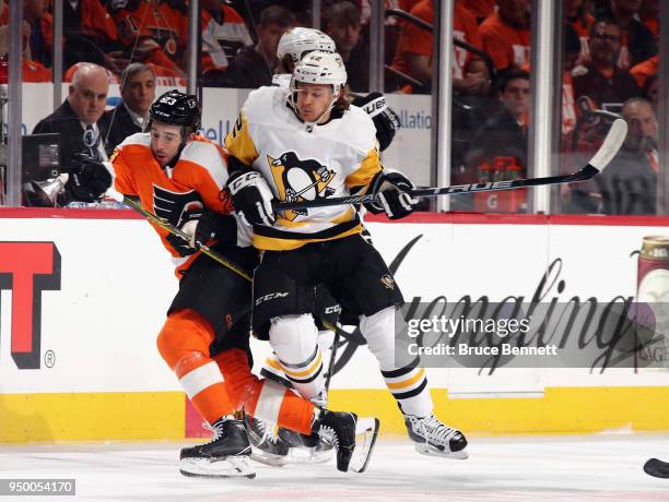 Carl Hagelin of the Pittsburgh Penguins steps into Brandon Manning of the Philadelphia Flyers during the first period in Game Six of the Eastern...