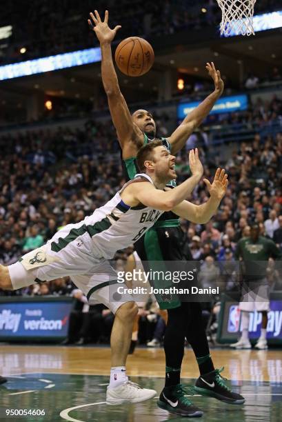 Matthew Dellavedova of the Milwaukee Bucks looses the ball after being fouled by Al Horford of the Boston Celtics during Game Four of Round One of...