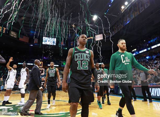 As Milwaukee's Jabari Parker and Thon Maker celebrate in the background at far left, the streamers celebrating the Bucks victory start to fall from...