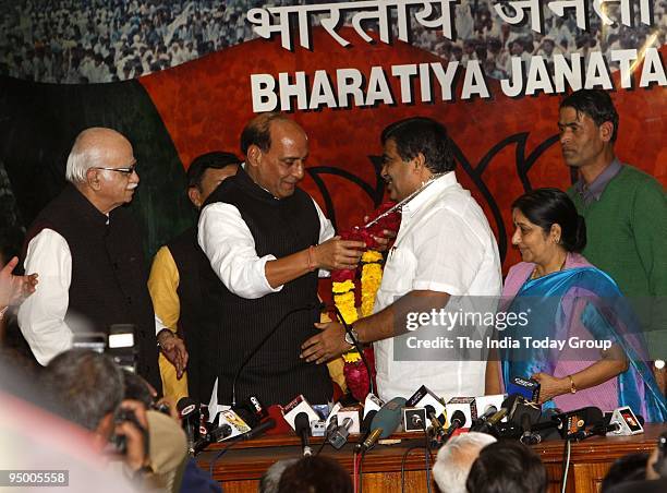 Rajnath Singh greets new BJP president Nitin Gadkari at the party office in New Delhi on Saturday, December 19, 2009.