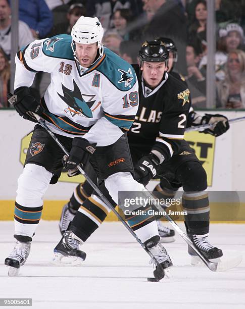 Joe Thornton of the San Jose Sharks tries to keep the puck away against Nicklas Grossman of the Dallas Stars on December 21, 2009 at the American...
