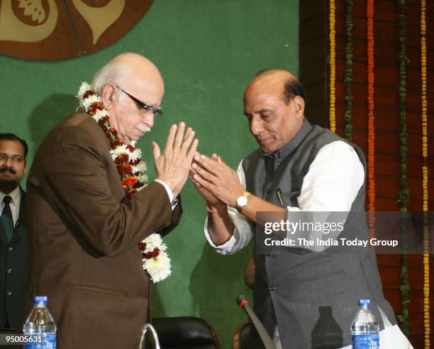 Rajnath Singh congratulates L.K. Advani with a garland for being chosen the chairperson of BJP Parliamentary Board in New Delhi on December 18, 2009.