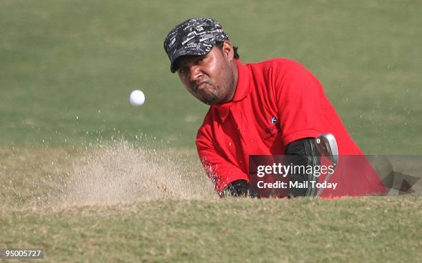 Indian golfer Ashok Kumar hits a shot at the third round of the PGTI Tour Golf Championship in Manesar, Haryana on Friday, December 18, 2009.