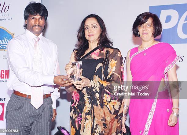 Hockey player Dhanraj Pillai and actress Hema Malini at an event to celebrate People for Ethical Treatment of Animals India's 10th anniversary in...