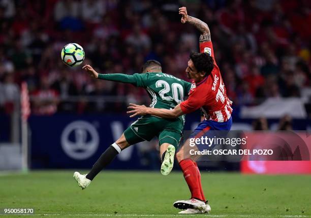 Atletico Madrid's Montenegrin defender Stefan Savic vies with Betis' midfielder Tello Herrera during the Spanish league football match between Club...