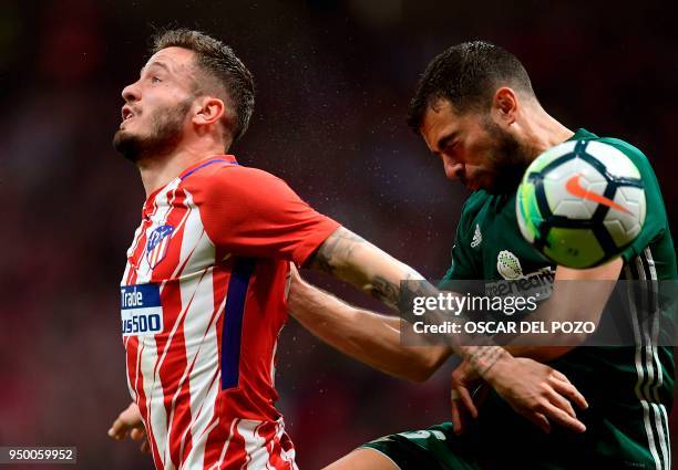 Atletico Madrid's Spanish midfielder Saul vies with Real Betis' Algerian defender Aissa Mandi during the Spanish league football match between Club...