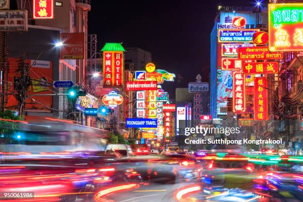 cars and shops on yaowarat road. chinatown with notable chinese buildings, restaurants and decoration. busy yaowarat road in the evening. chinese new year - bangkok night stock pictures, royalty-free photos & images