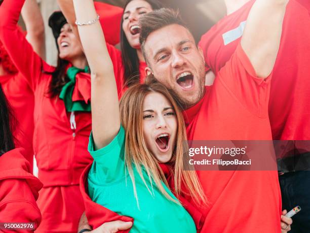 fans at stadium together - fans embracing stock pictures, royalty-free photos & images