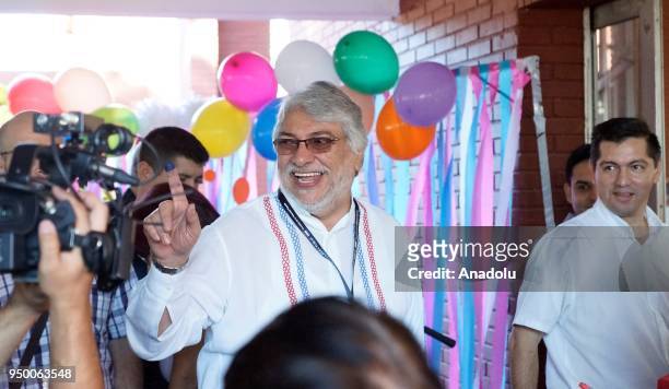 Paraguayan former President Fernando Lugo shows his inked finger after voting at a polling station during the presidential election in Asuncion,...