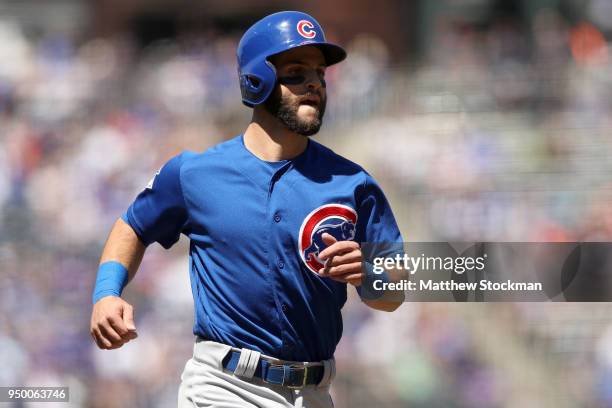 Tommy La Stella of the Chicago Cubs scores on a Victor Csaratini RBI single in the first inning against the Colorado Rockies at Coors Field on April...