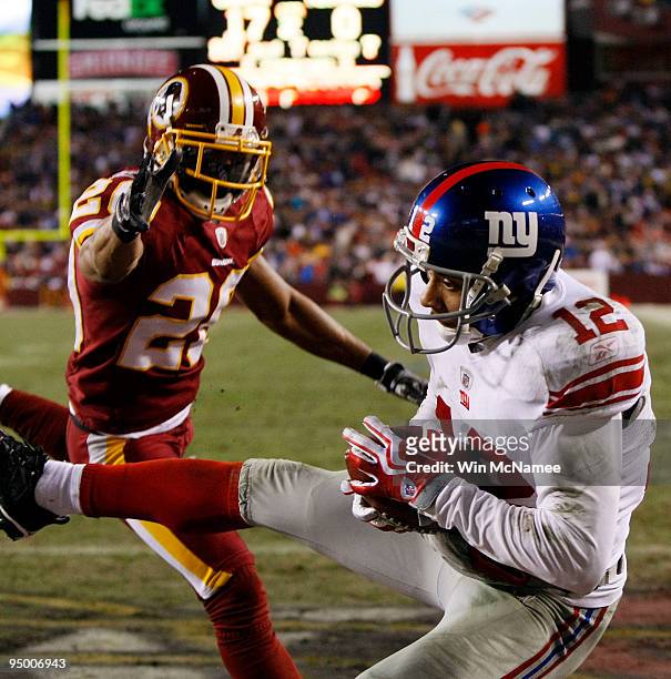 Wide receiver Steve Smith of the New York Giants catches a pass for a touchdown against Justin Tryon the Washington Redskins at FedEx Field on...
