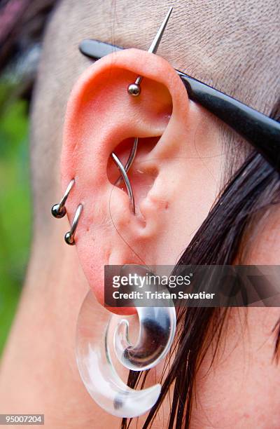 ear piercings and body jewelry - earlobe stockfoto's en -beelden