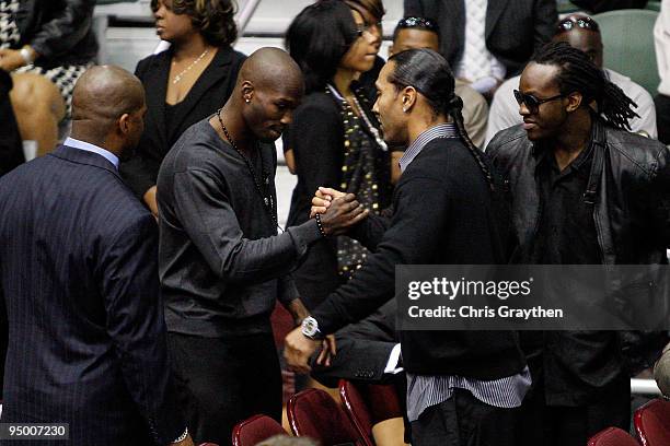 Cincinnati Bengals player Chad Ochocinco hugs Seattle Seahawks player T. J. Houshmandzadeh during the funeral for Cincinnati Bengals player Chris...